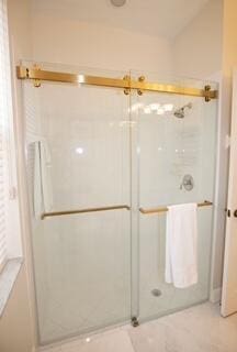 bathroom with a shower with shower door