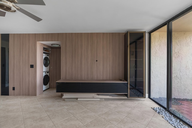 interior space with ceiling fan and stacked washing maching and dryer