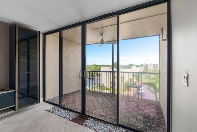 unfurnished sunroom featuring a wealth of natural light and ceiling fan