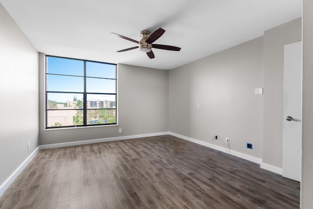 unfurnished room with dark hardwood / wood-style floors and ceiling fan