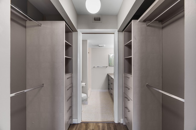 walk in closet featuring dark hardwood / wood-style floors