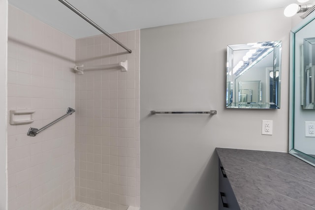 bathroom featuring vanity and a tile shower