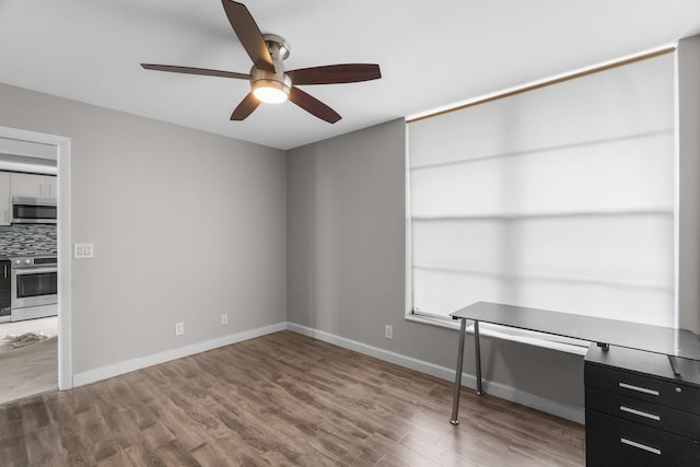 spare room featuring hardwood / wood-style floors and ceiling fan