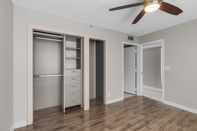 unfurnished bedroom with dark hardwood / wood-style floors and ceiling fan