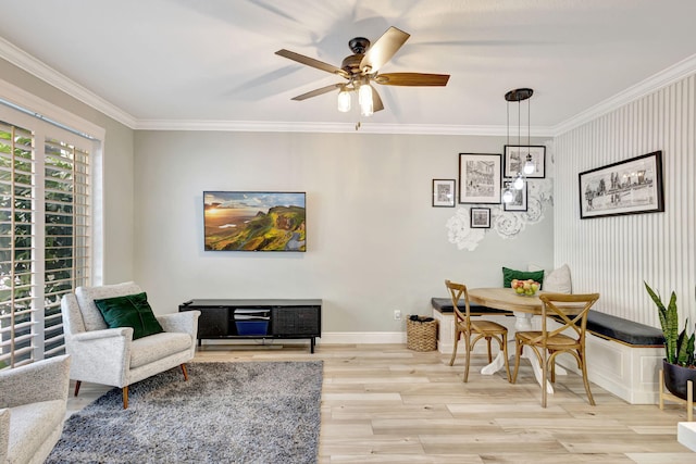 dining room featuring ceiling fan, light hardwood / wood-style floors, and crown molding