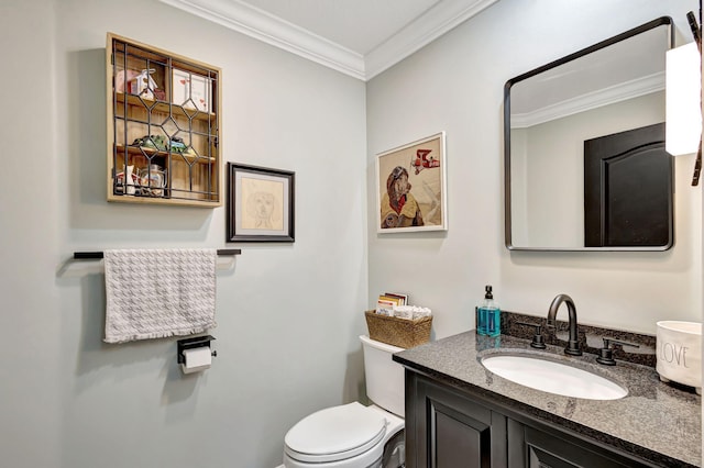 bathroom with vanity, toilet, and ornamental molding