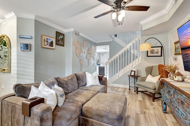 living room featuring ceiling fan, light hardwood / wood-style flooring, and ornamental molding