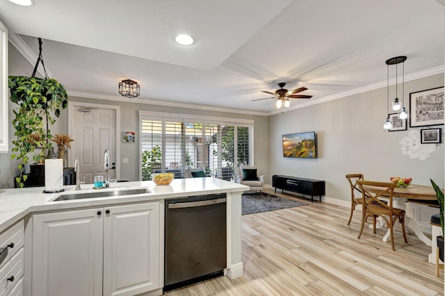 kitchen featuring sink, stainless steel dishwasher, pendant lighting, white cabinets, and light wood-type flooring