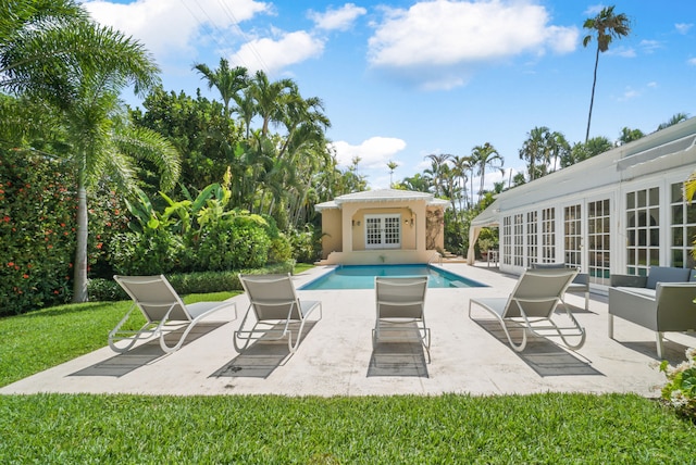 view of swimming pool featuring french doors and a patio area