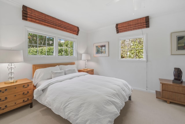 bedroom featuring light carpet, multiple windows, and ceiling fan