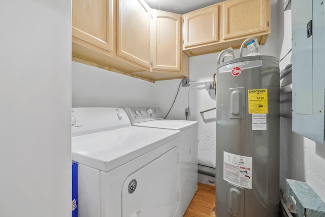 laundry area featuring cabinets, electric water heater, electric panel, light hardwood / wood-style floors, and washer and clothes dryer