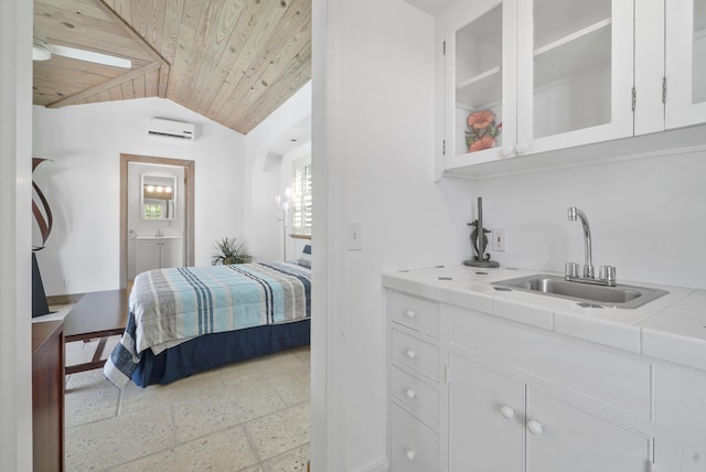 bedroom with an AC wall unit, sink, wood ceiling, and vaulted ceiling