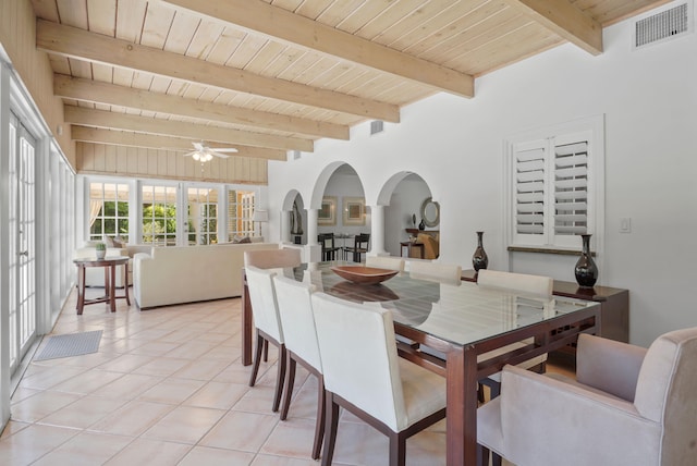 dining room featuring ceiling fan, beam ceiling, wood ceiling, and light tile patterned floors