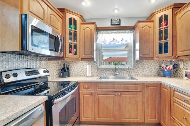 kitchen with decorative backsplash, stainless steel appliances, and sink