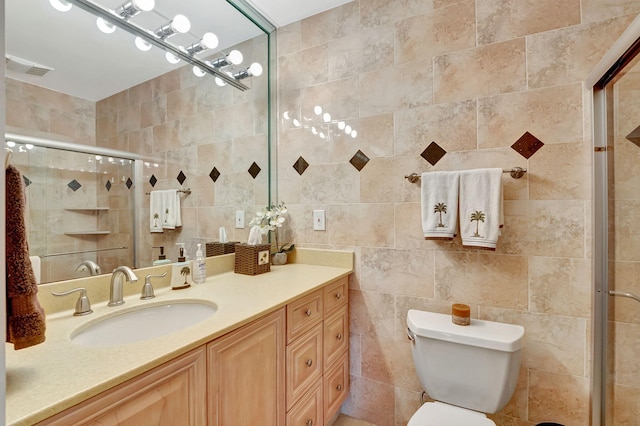 bathroom featuring vanity, toilet, walk in shower, and tile walls