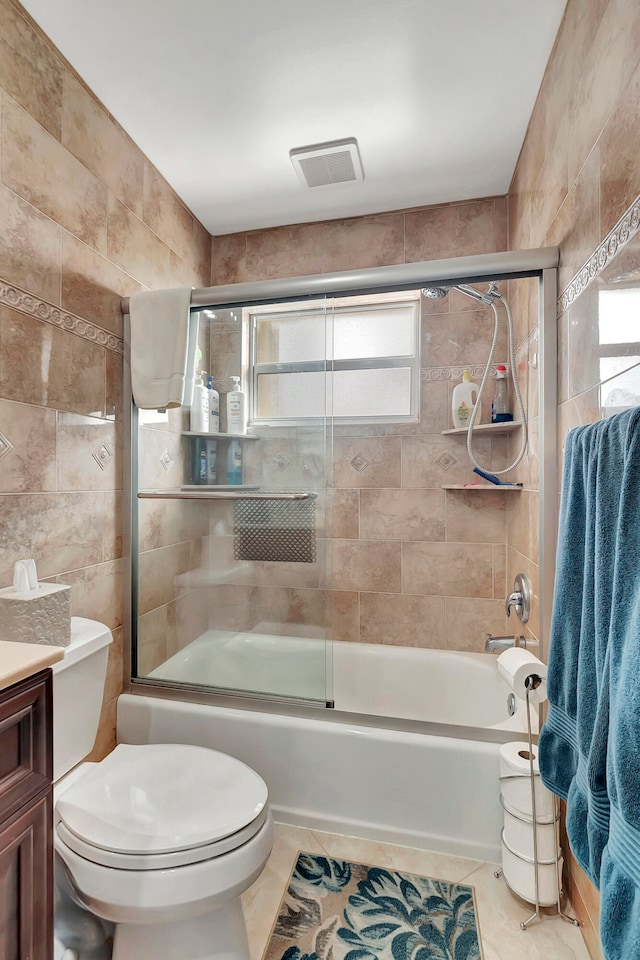 full bathroom with tile patterned floors, a healthy amount of sunlight, and tile walls