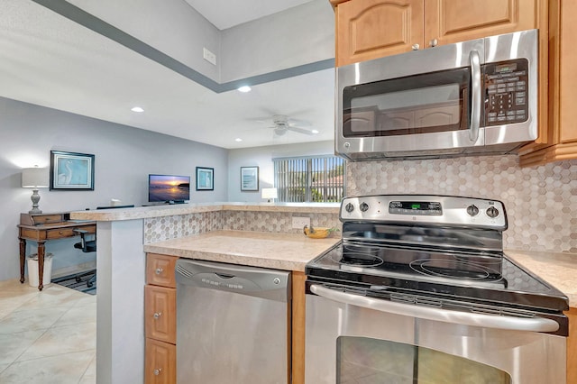 kitchen with appliances with stainless steel finishes, tasteful backsplash, ceiling fan, and light tile patterned flooring