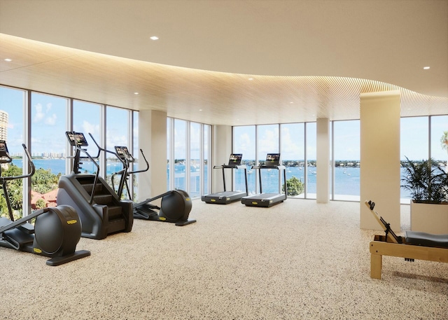 gym featuring expansive windows and a water view