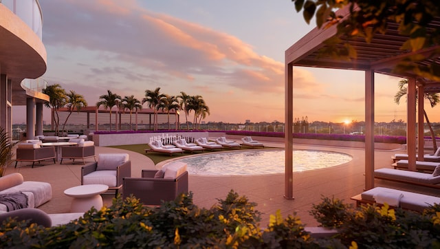 pool at dusk with an outdoor living space and a patio area