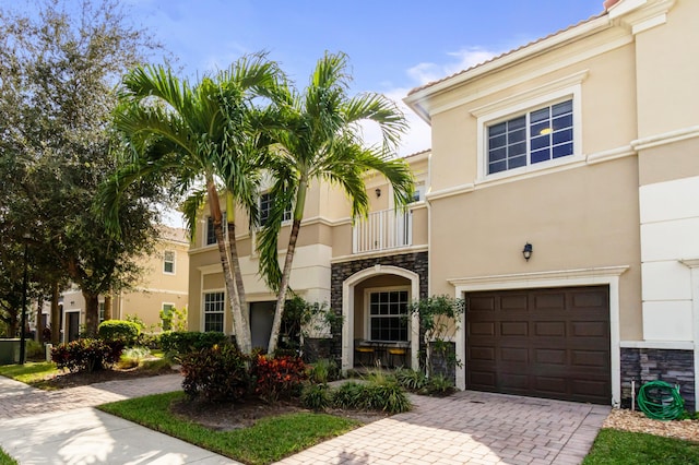 view of front of property with a balcony and a garage