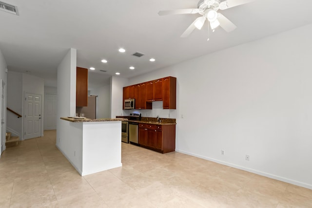 kitchen featuring kitchen peninsula, appliances with stainless steel finishes, ceiling fan, sink, and light tile patterned floors