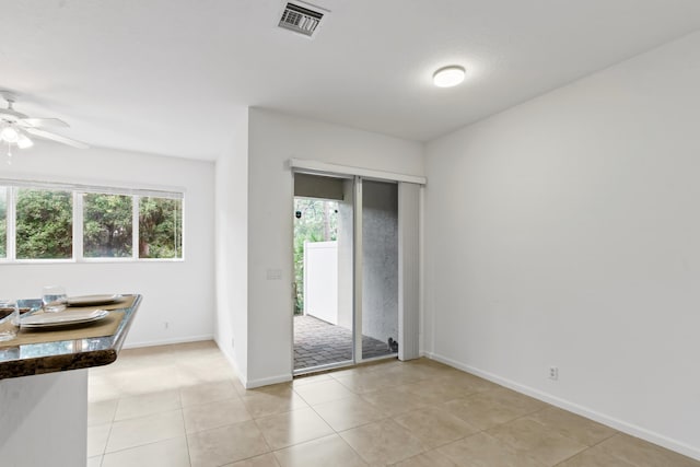 6120 SE Portofino Cir, Hobe Sound, FL 33455 - dining space featuring plenty of natural light, ceiling fan, light tile patterned floors, and baseboards