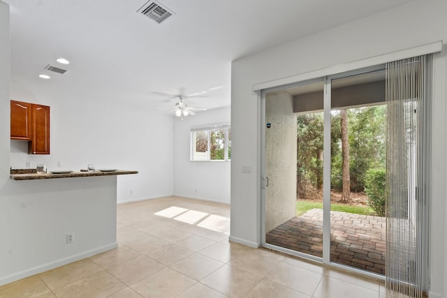 interior space featuring ceiling fan and light tile patterned floors