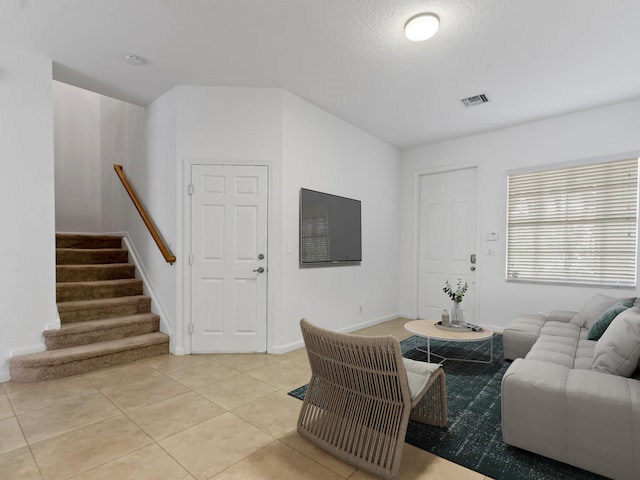 living room with light tile patterned floors and a textured ceiling