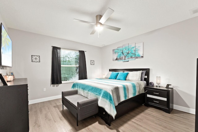 bedroom with ceiling fan and light hardwood / wood-style floors