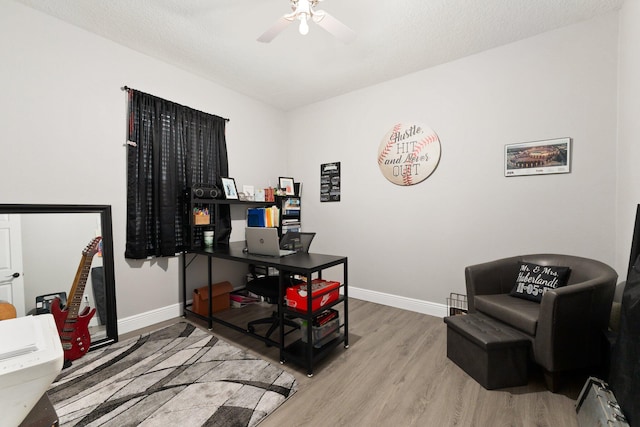 office featuring hardwood / wood-style floors, a textured ceiling, and ceiling fan