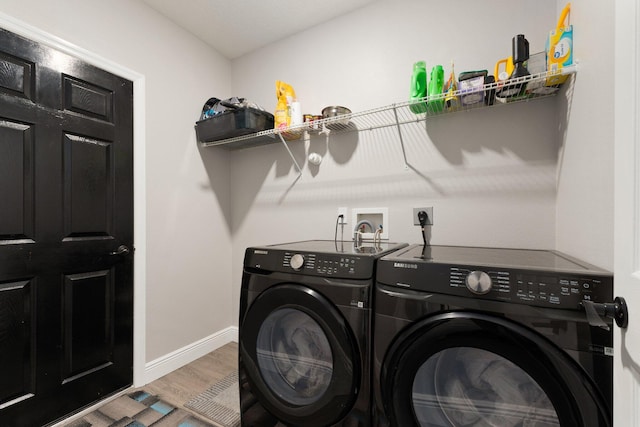 clothes washing area featuring separate washer and dryer and hardwood / wood-style flooring