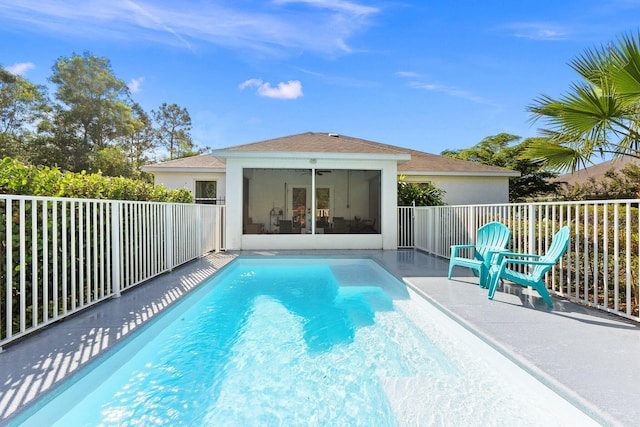 view of swimming pool with ceiling fan and a sunroom