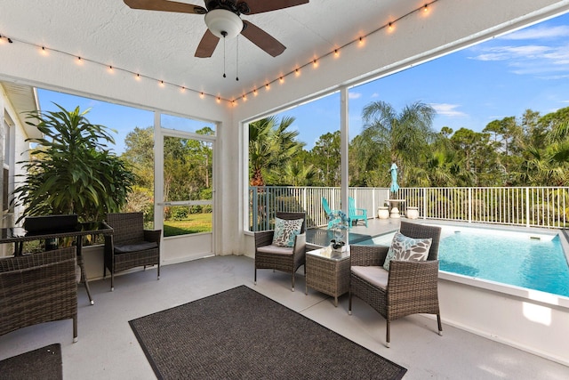 sunroom featuring ceiling fan