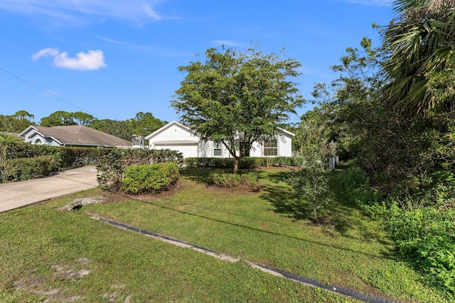 view of front facade featuring a garage and a front lawn