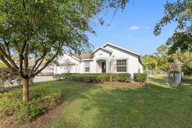 view of front of home with a garage and a front lawn