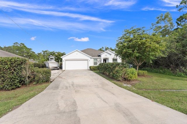 view of front of house featuring a garage and a front lawn