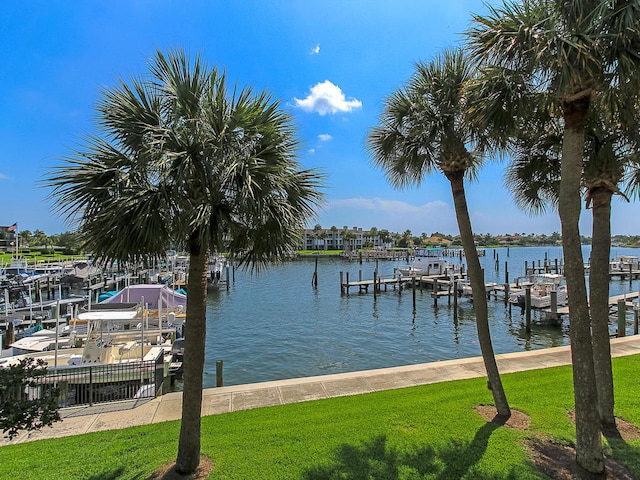 dock area featuring a lawn and a water view