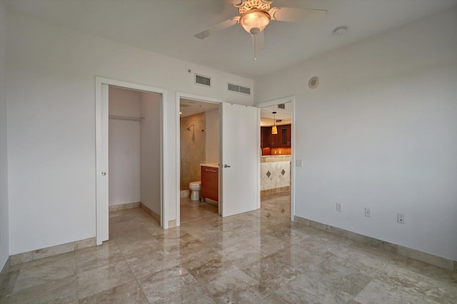 unfurnished bedroom with ceiling fan, a spacious closet, connected bathroom, and a closet