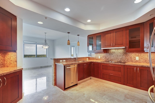 kitchen with light stone countertops, dishwasher, sink, decorative light fixtures, and decorative backsplash