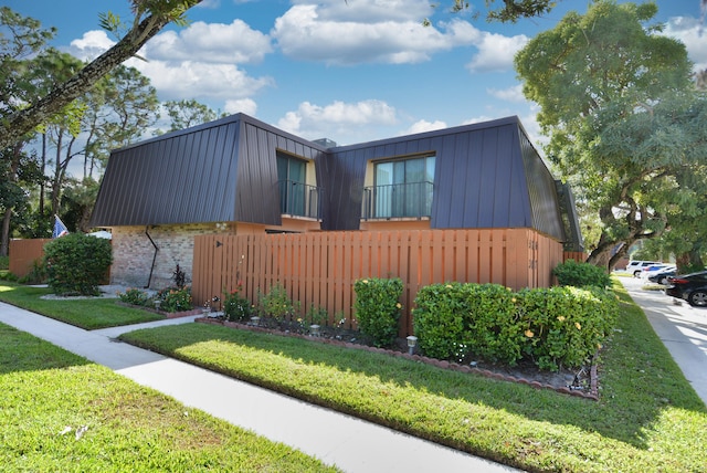 view of side of property with a lawn