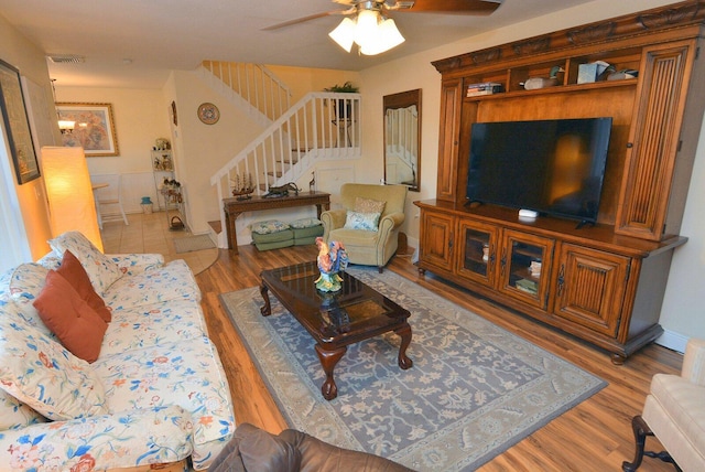 living room featuring ceiling fan and wood-type flooring