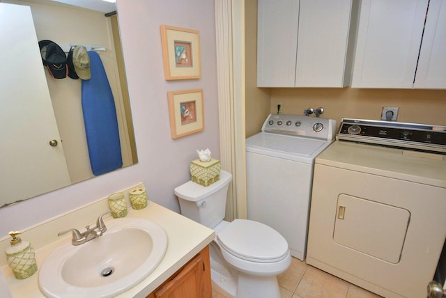 bathroom with tile patterned floors, vanity, toilet, and separate washer and dryer