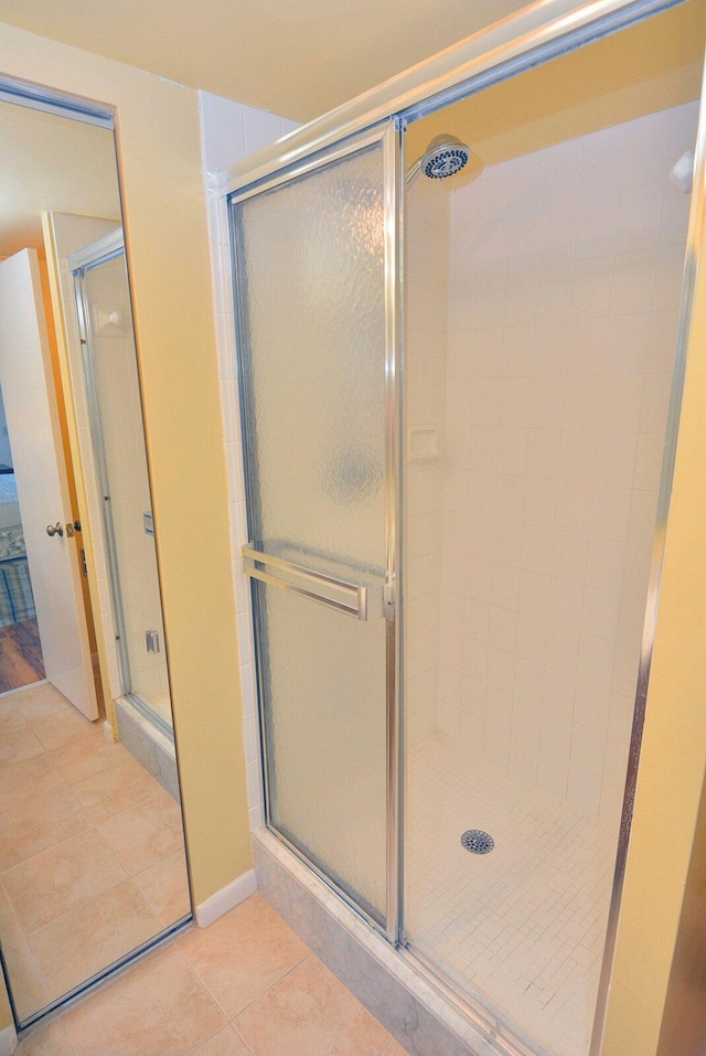 bathroom featuring tile patterned flooring and a shower with shower door