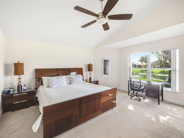 bedroom with ceiling fan, light colored carpet, and vaulted ceiling