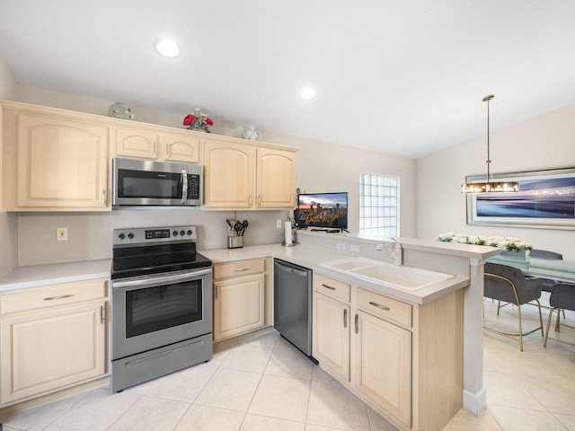 kitchen with sink, hanging light fixtures, kitchen peninsula, light tile patterned flooring, and appliances with stainless steel finishes