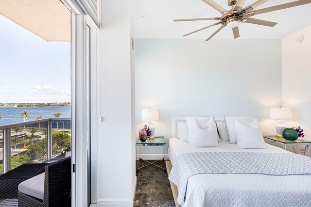 bedroom featuring a water view and ceiling fan