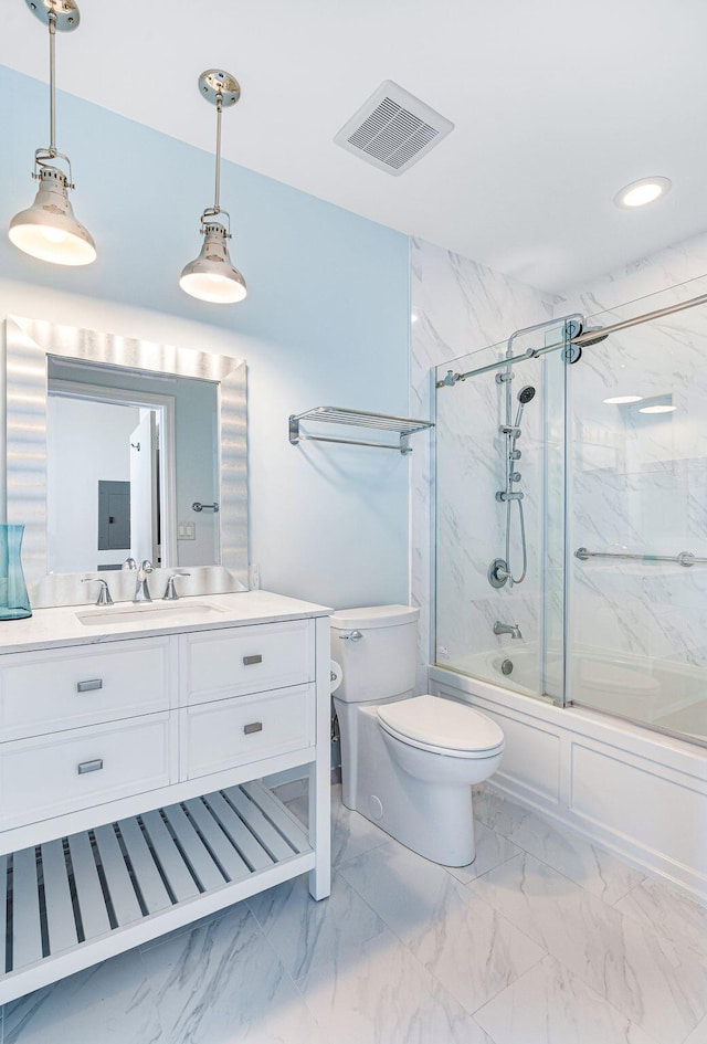 full bathroom with toilet, vanity, and shower / bath combination with glass door