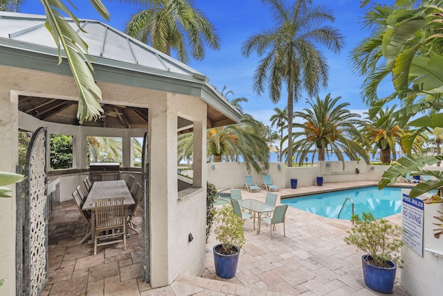 view of swimming pool with a gazebo, area for grilling, exterior bar, and a patio area