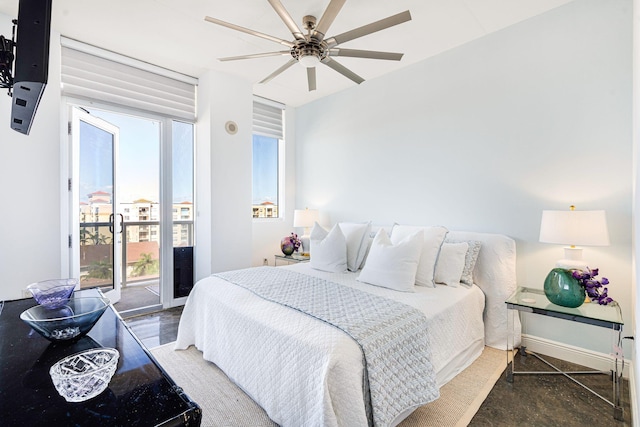 bedroom with ceiling fan, multiple windows, and access to outside