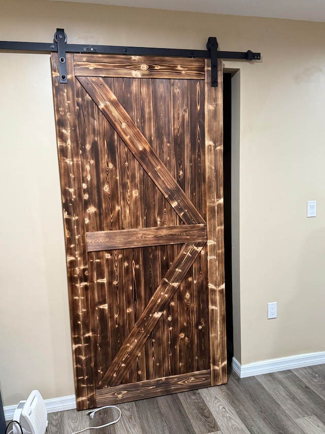 interior details featuring hardwood / wood-style floors and a barn door